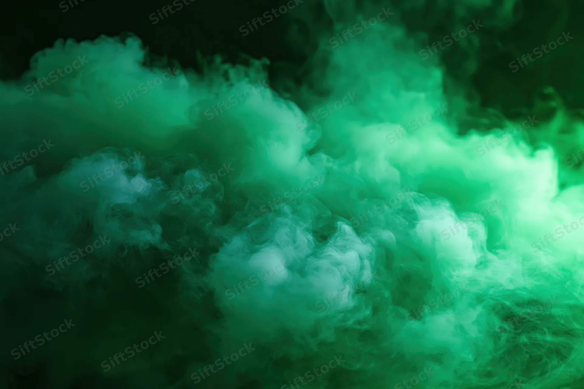 Dense green smoke billowing and swirling in dark space