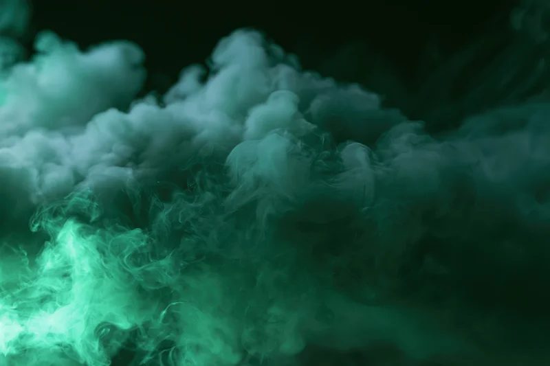 Swirling green smoke clouds filling the frame against a dark background