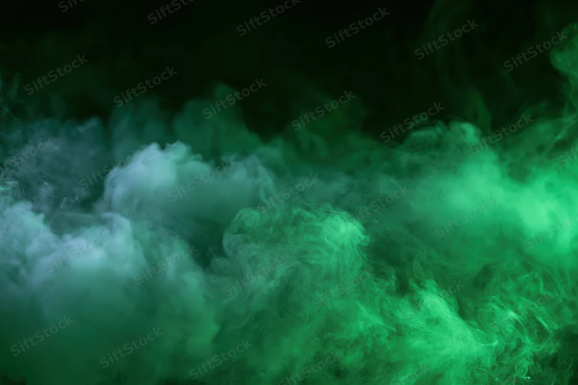 Dense billowing green smoke swirling in dark space