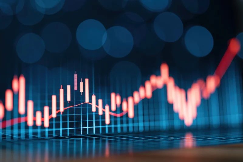 Glowing candlestick chart on digital display showing upward market trend