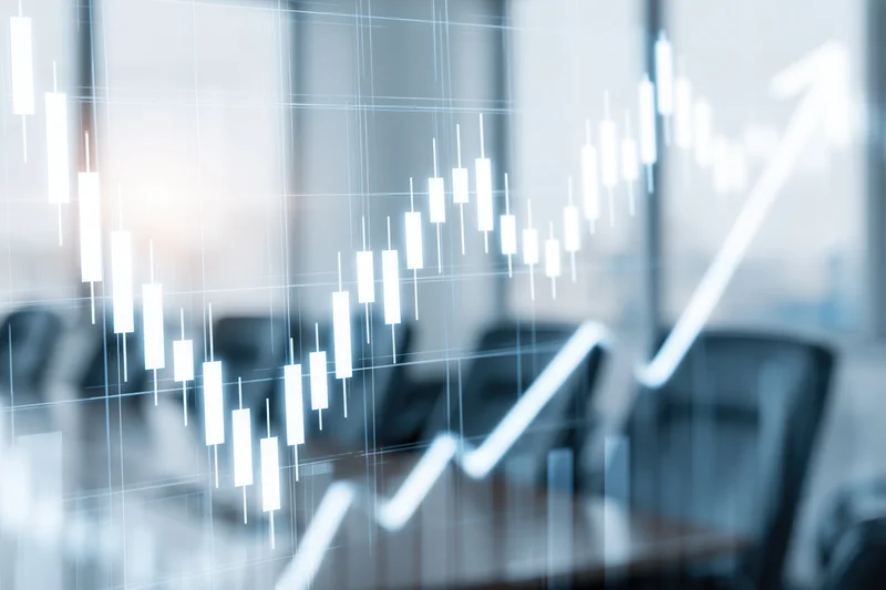 Glowing financial candlestick chart overlaying a blurred office meeting room