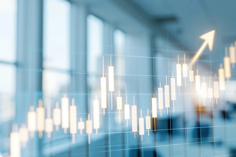 Glowing candlestick chart with upward arrow overlaid on blurred office window view