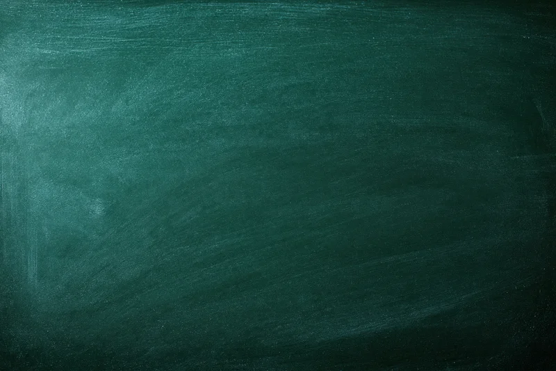Dark green chalkboard surface filling the frame with faint smudges and texture