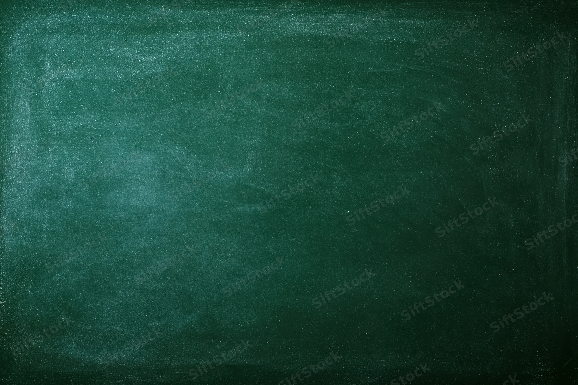 Dark green chalkboard surface filling the frame with smudged texture and copyspace