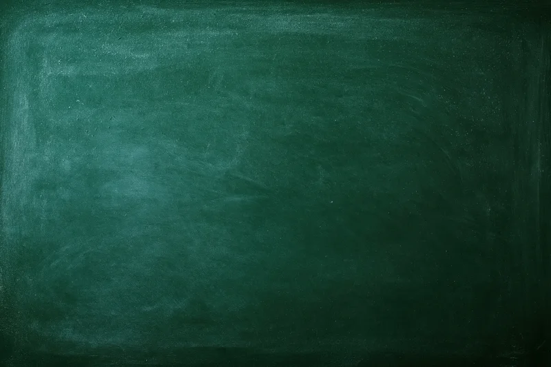 Dark green chalkboard surface filling the frame with smudged texture and copyspace