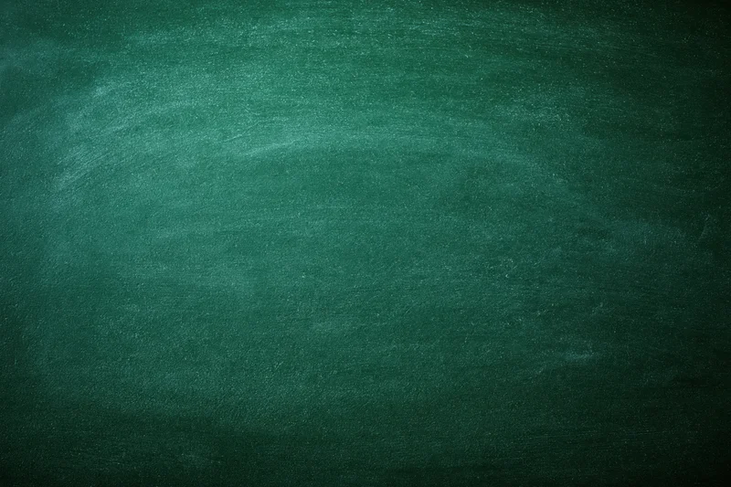 Dark green chalkboard surface filling the frame with faint chalk residue and texture