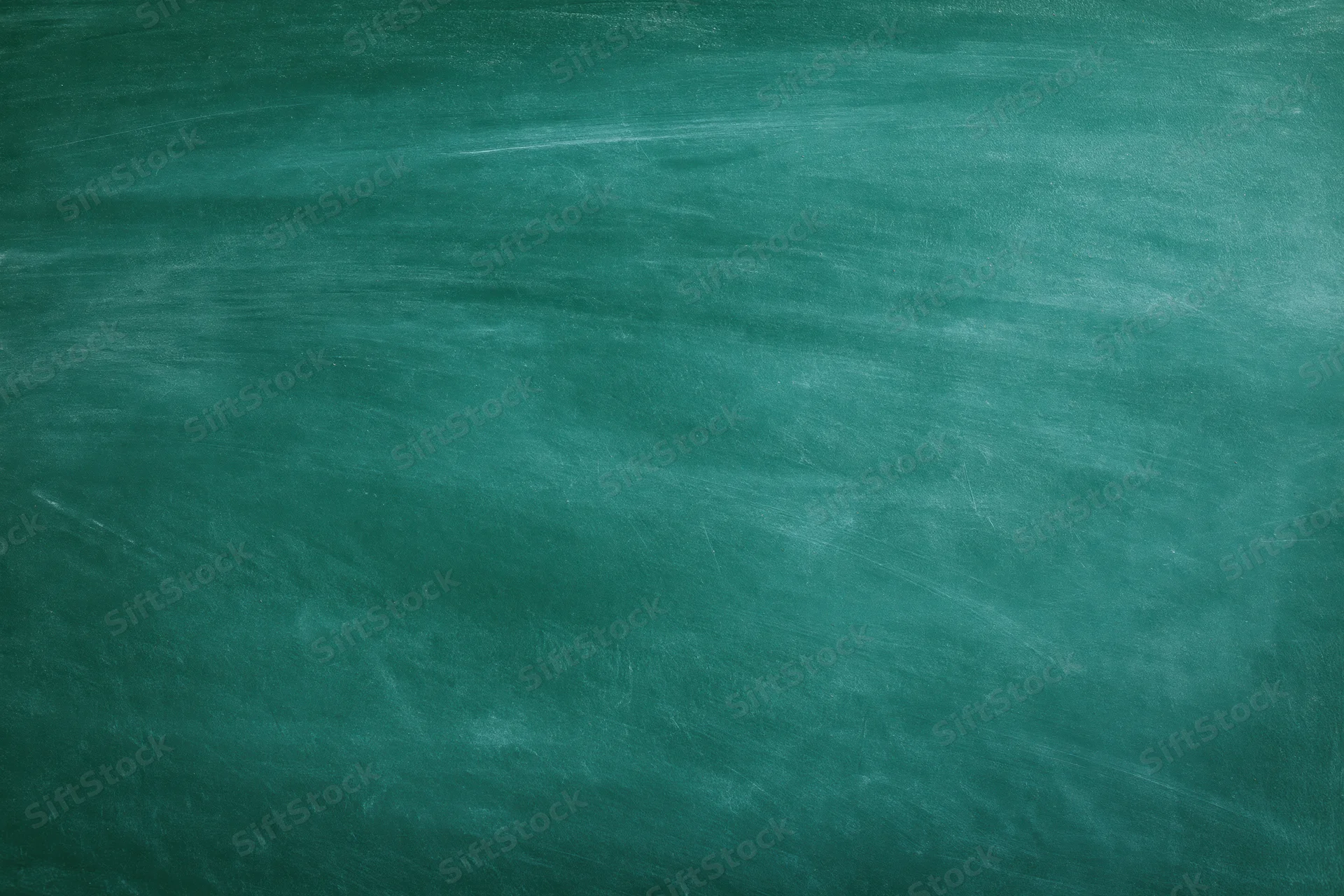Empty green chalkboard surface filling the frame with faint smudges and erased marks