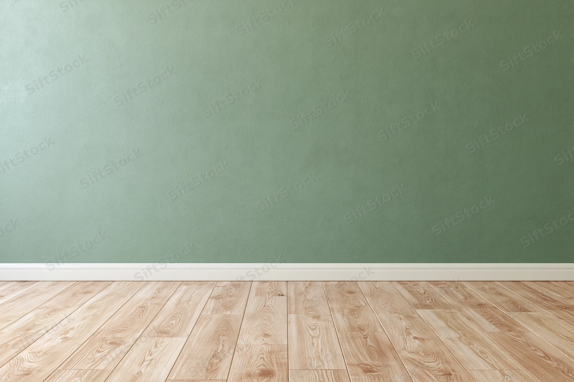 Empty room with sage green painted wall and wooden floor, white baseboard, minimalist interior space