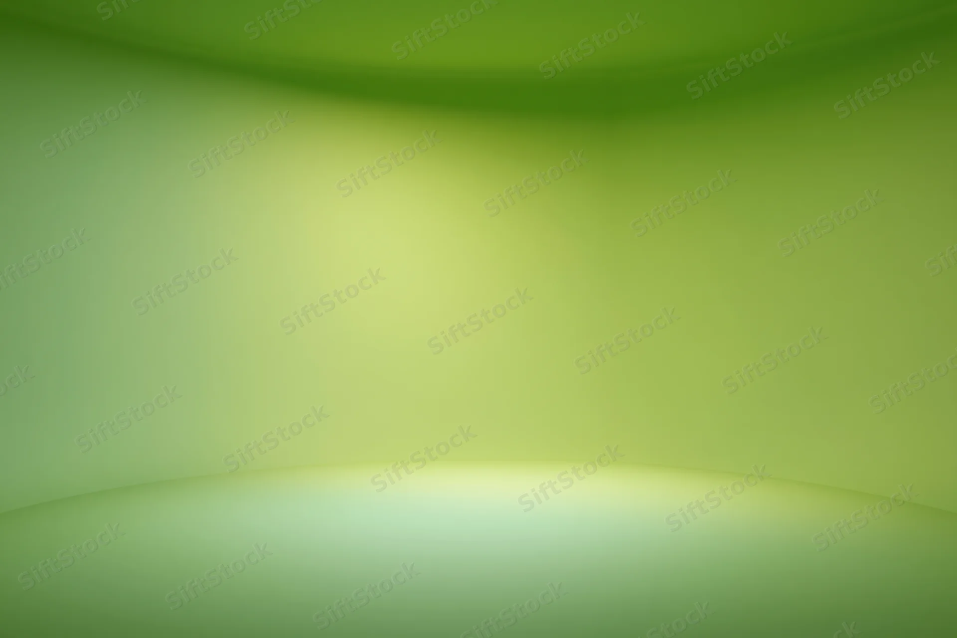 Smooth seamless green gradient backdrop in empty photo studio space