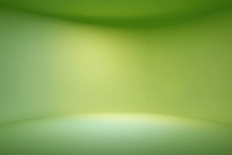 Smooth seamless green gradient backdrop in empty photo studio space