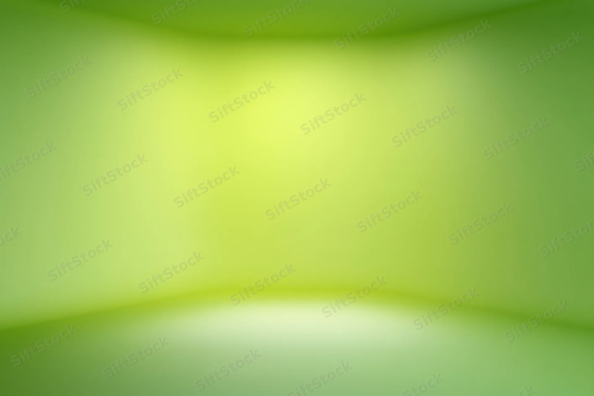 Smooth green gradient backdrop in an empty studio space