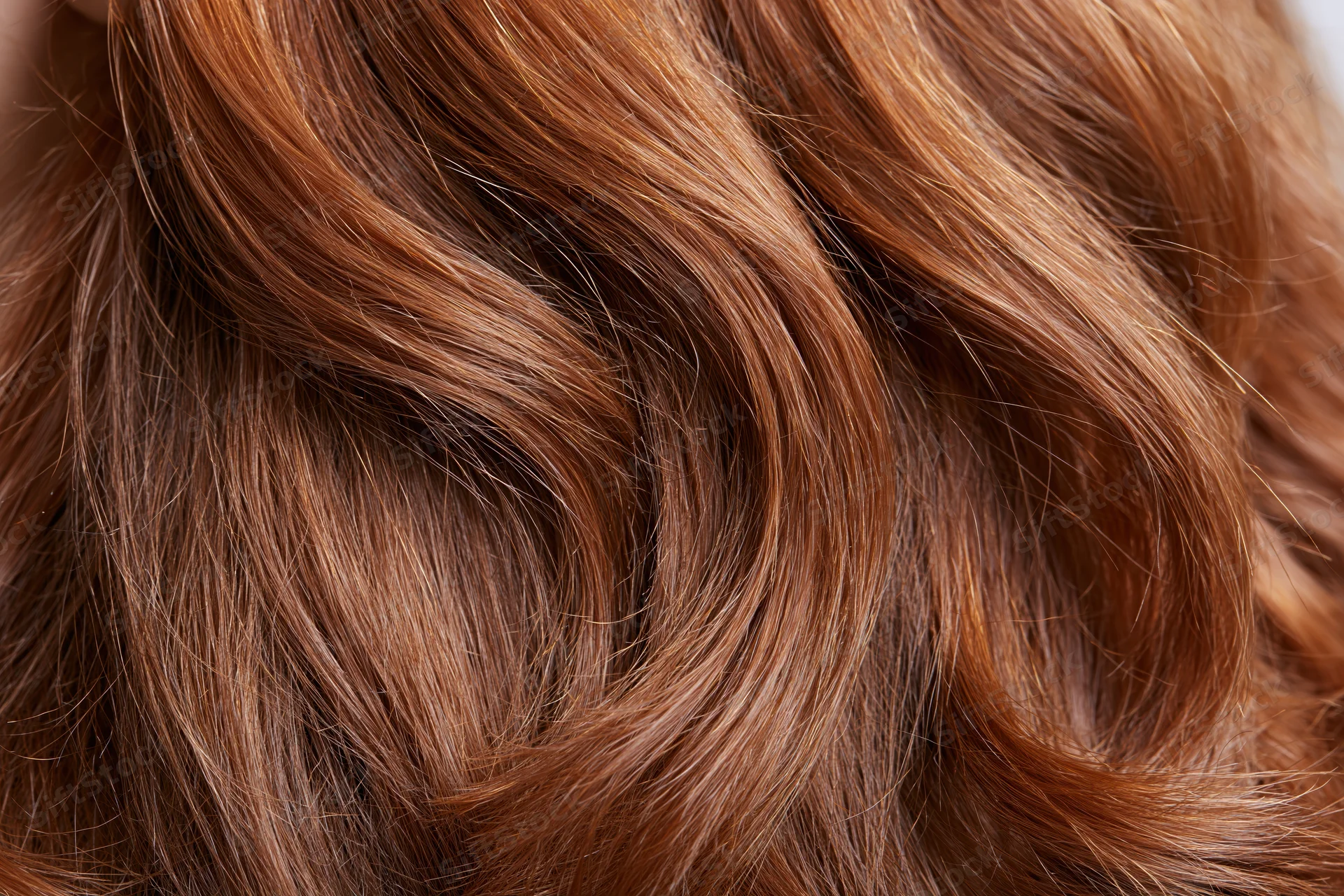 Closeup of wavy auburn hair showing texture and shine