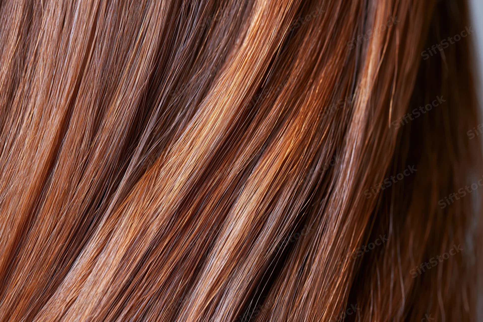Close-up of straight brown hair strands showing smooth texture and shine