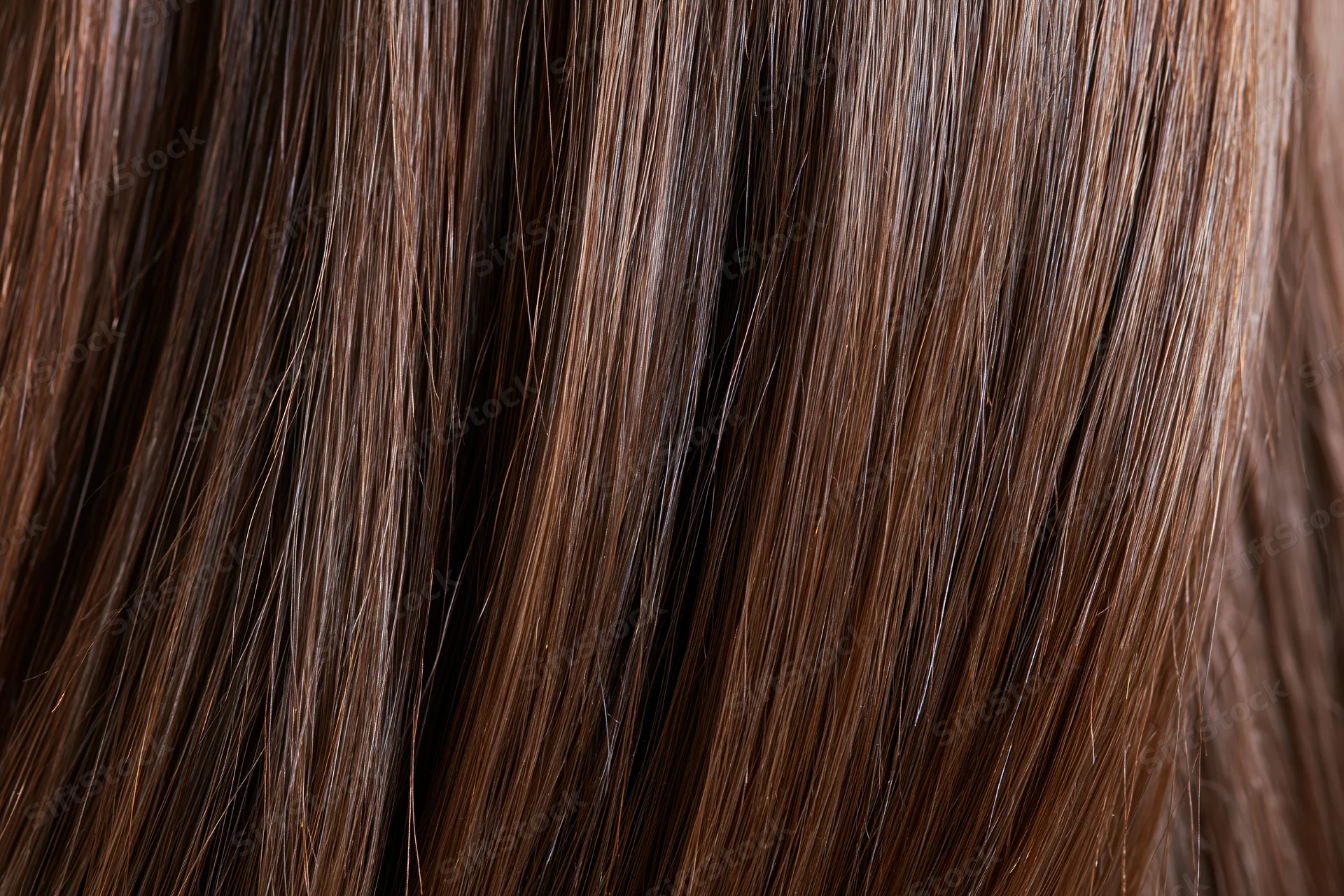 Close-up of straight brown hair strands showing smooth texture and shine