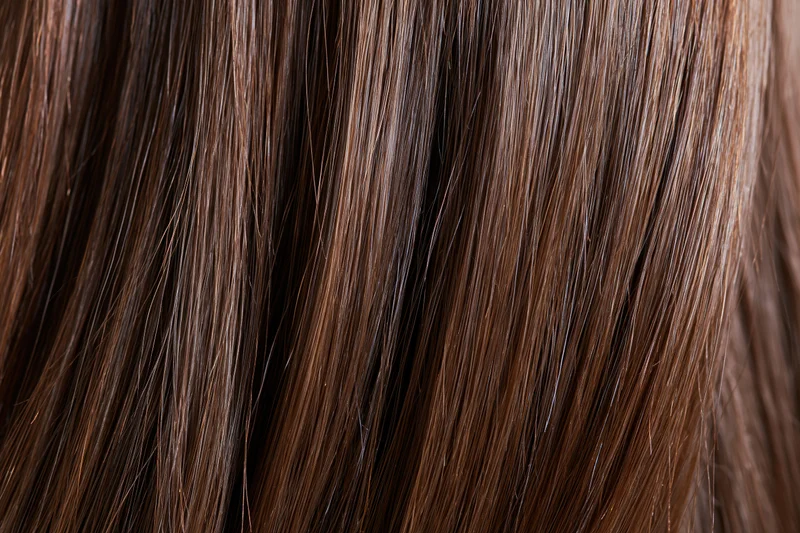 Close-up of straight brown hair strands showing smooth texture and shine