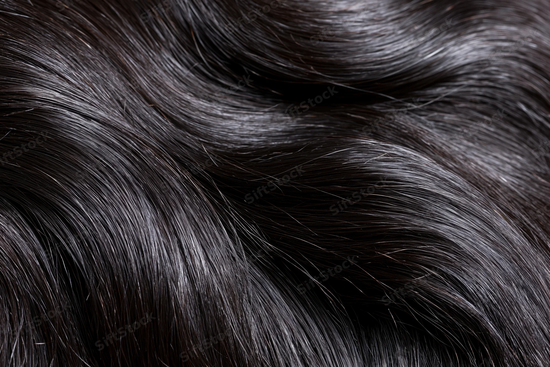 Extreme close-up of straight dark brown-black hair showing glossy texture and fine strands