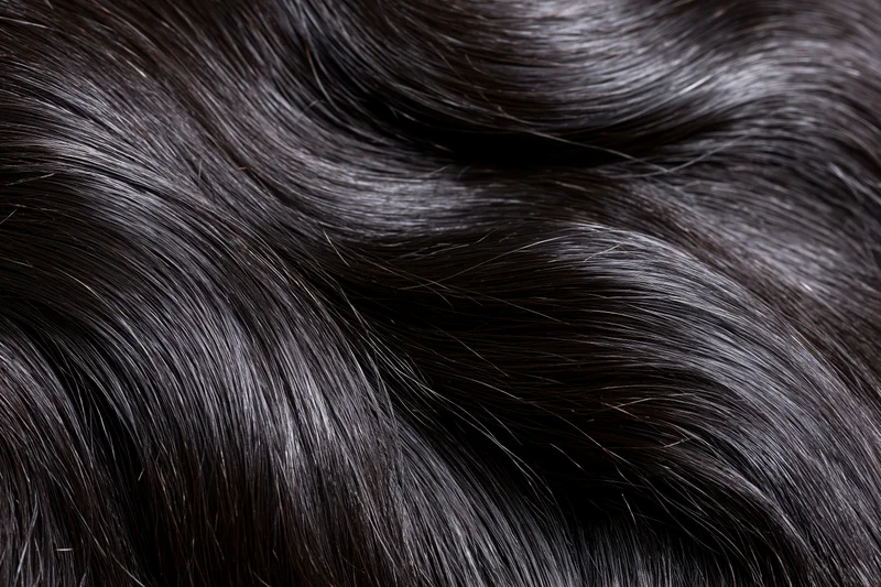 Extreme close-up of straight dark brown-black hair showing glossy texture and fine strands
