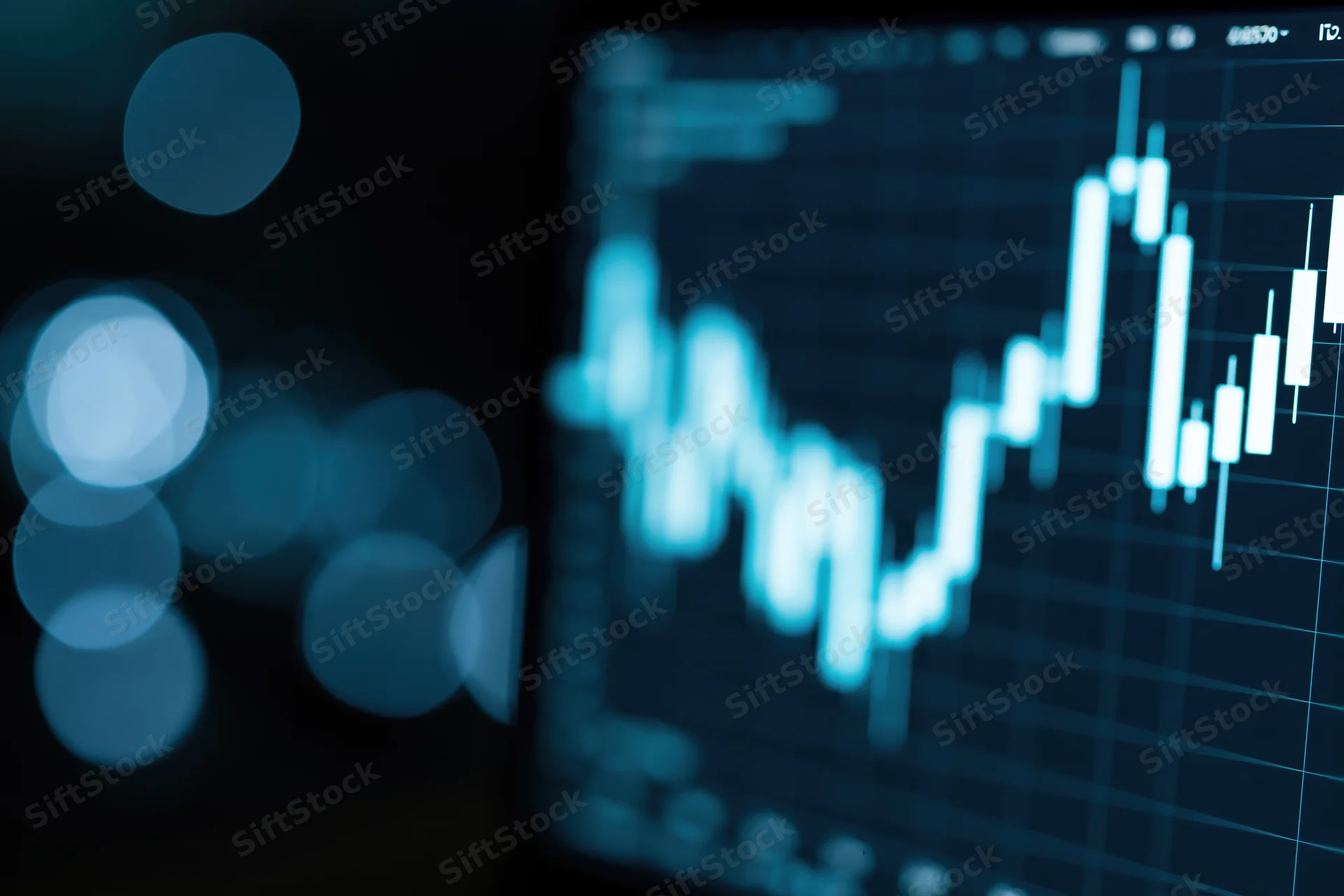 Financial candlestick chart showing upward trend on a dark digital screen