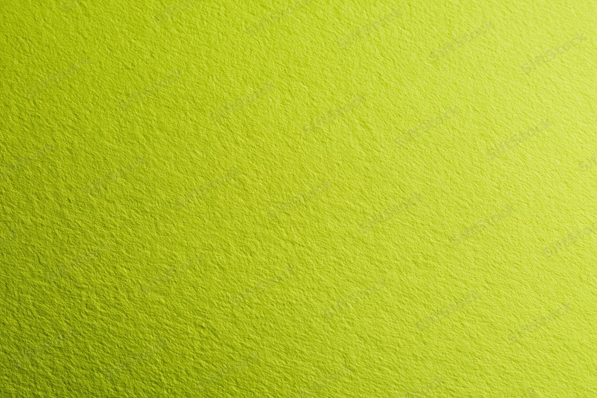 Close-up of smooth lime green paper surface with fine texture