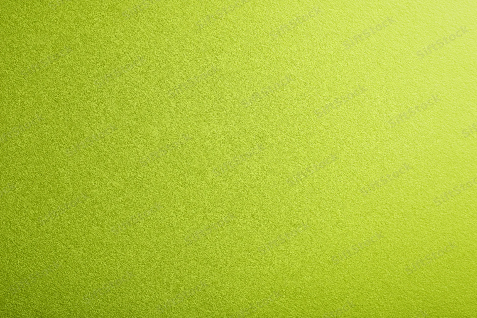 Close-up of smooth lime green paper surface with even texture and subtle gradient