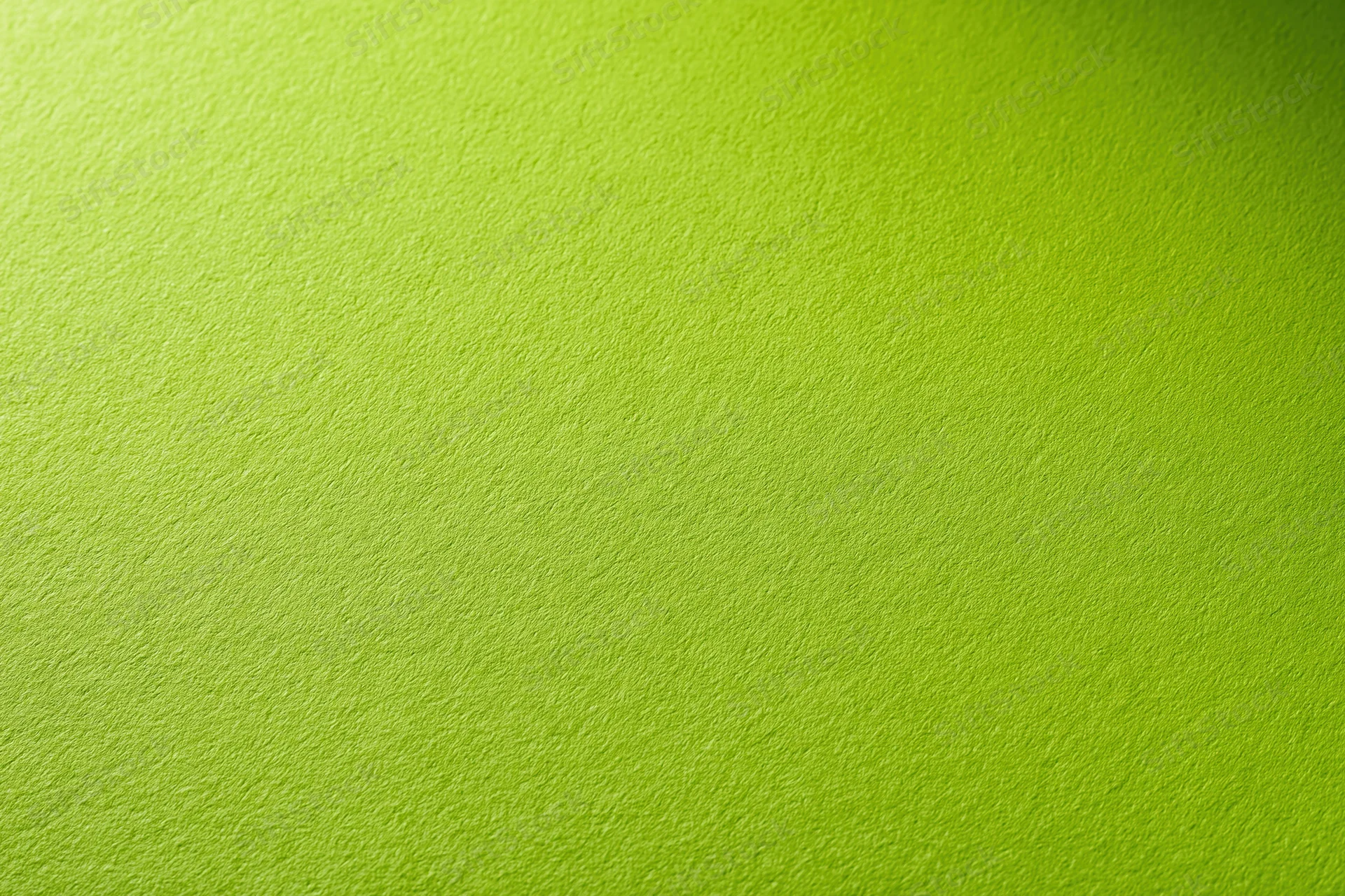 Close-up of smooth lime green paper surface with subtle texture