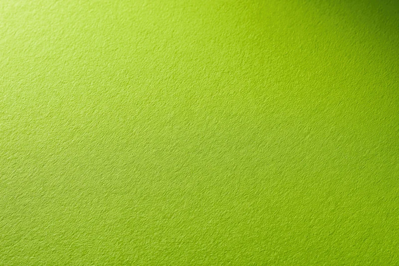 Close-up of smooth lime green paper surface with subtle texture