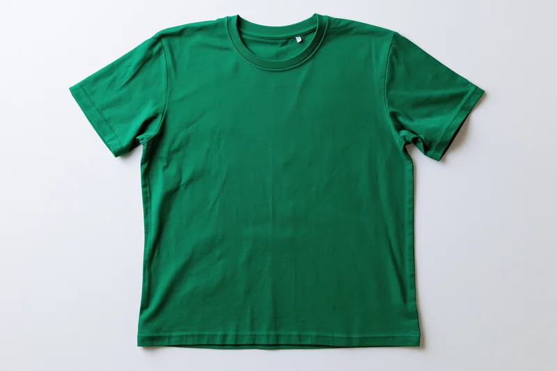 Plain green cotton crew-neck t-shirt laid flat on white background