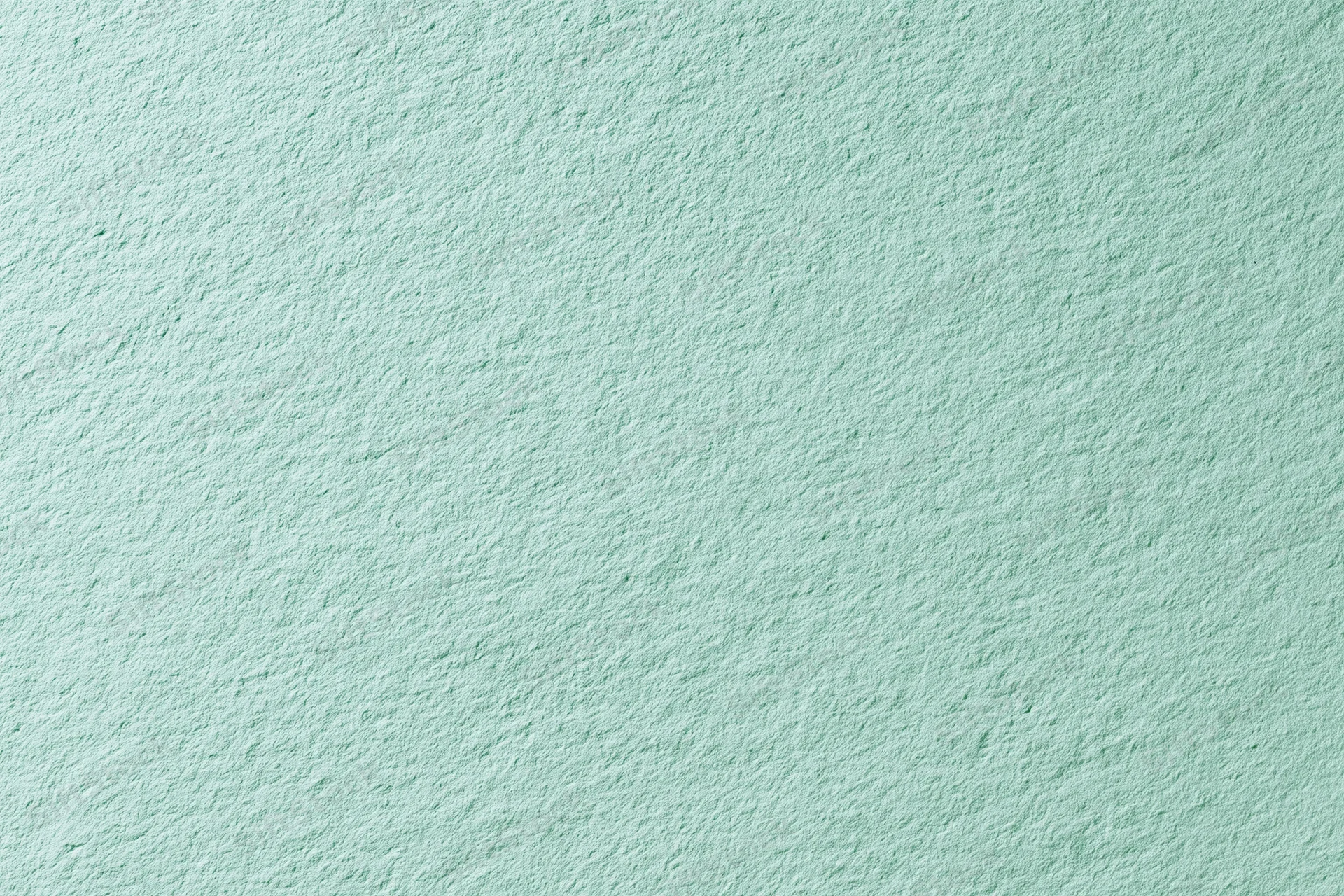 Close-up of a flat matte green painted wall surface filling the frame