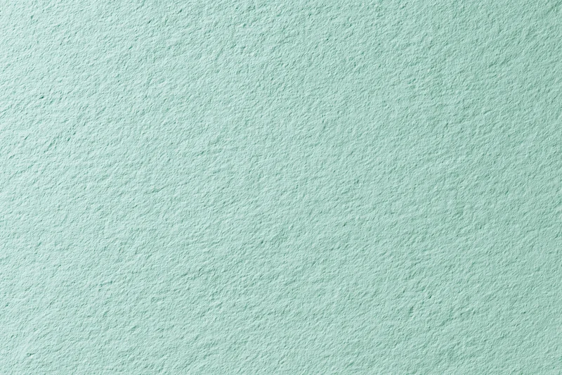 Close-up of a flat matte green painted wall surface filling the frame