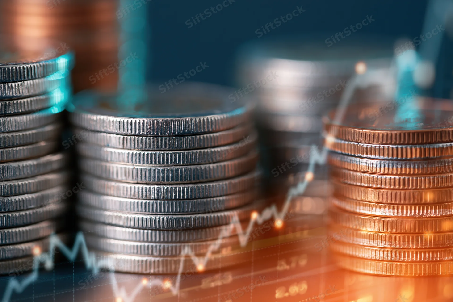 Stacks of silver and copper coins with digital graph overlay showing upward trend