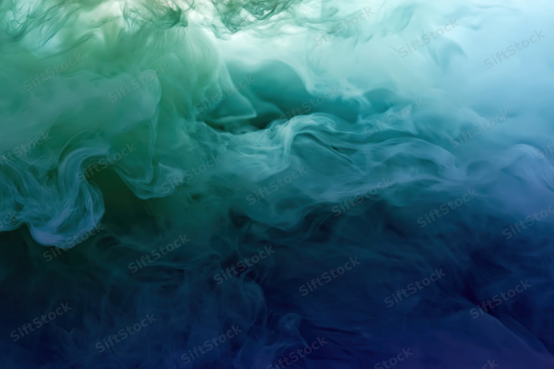 Swirling ink clouds dispersing in water full frame macro abstract
