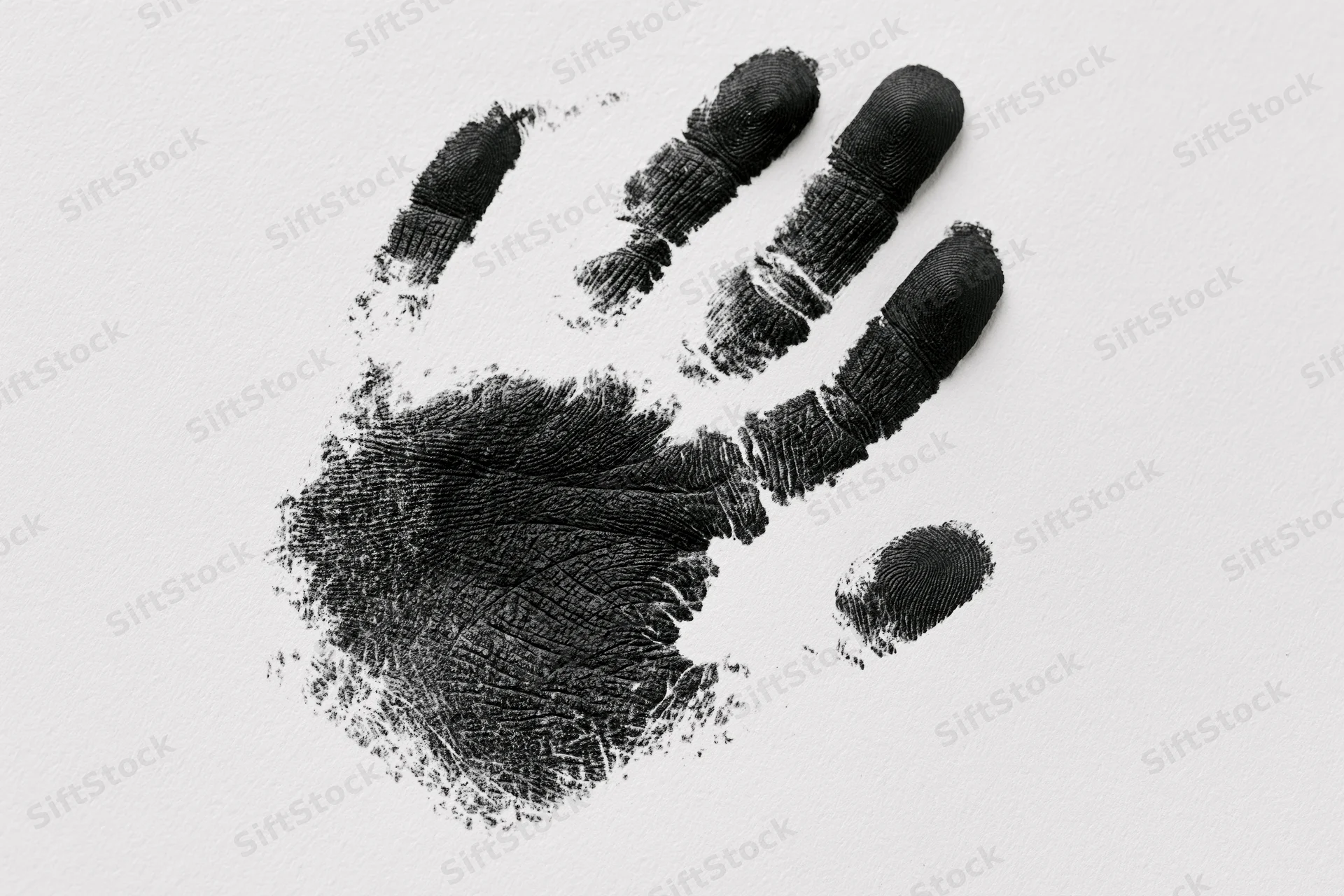 Black ink handprint of a child's right hand on white paper
