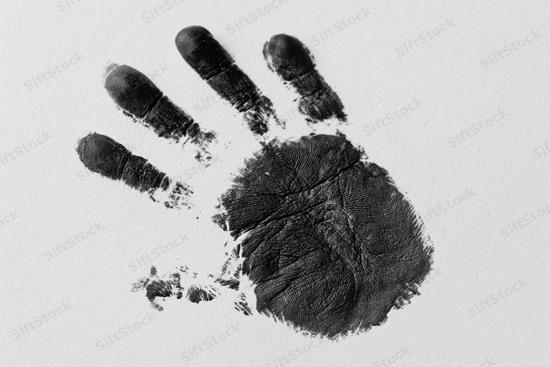 Black ink handprint of a child's right hand on white paper