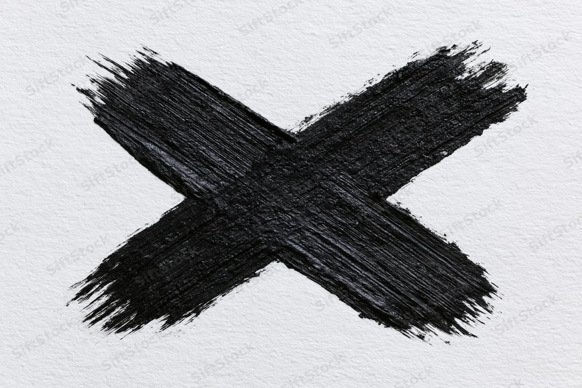 Bold hand-painted black x mark on textured white paper