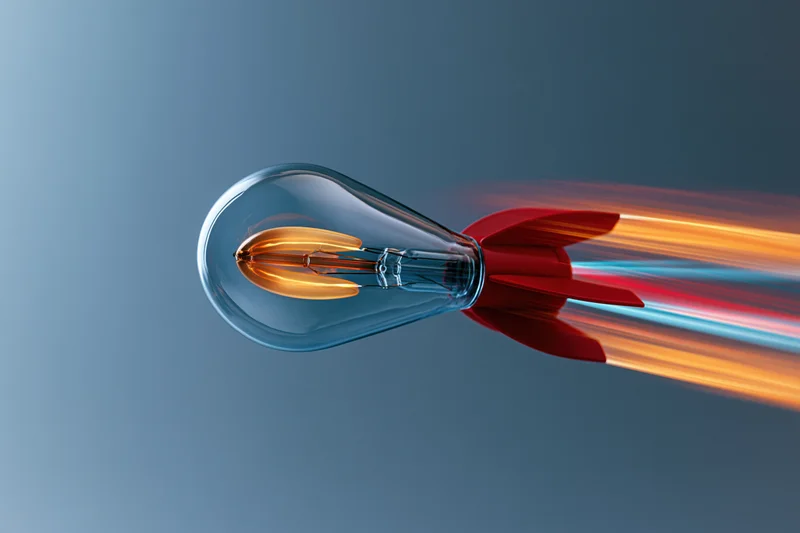 Lightbulb with red rocket fins launching forward leaving a fiery trail