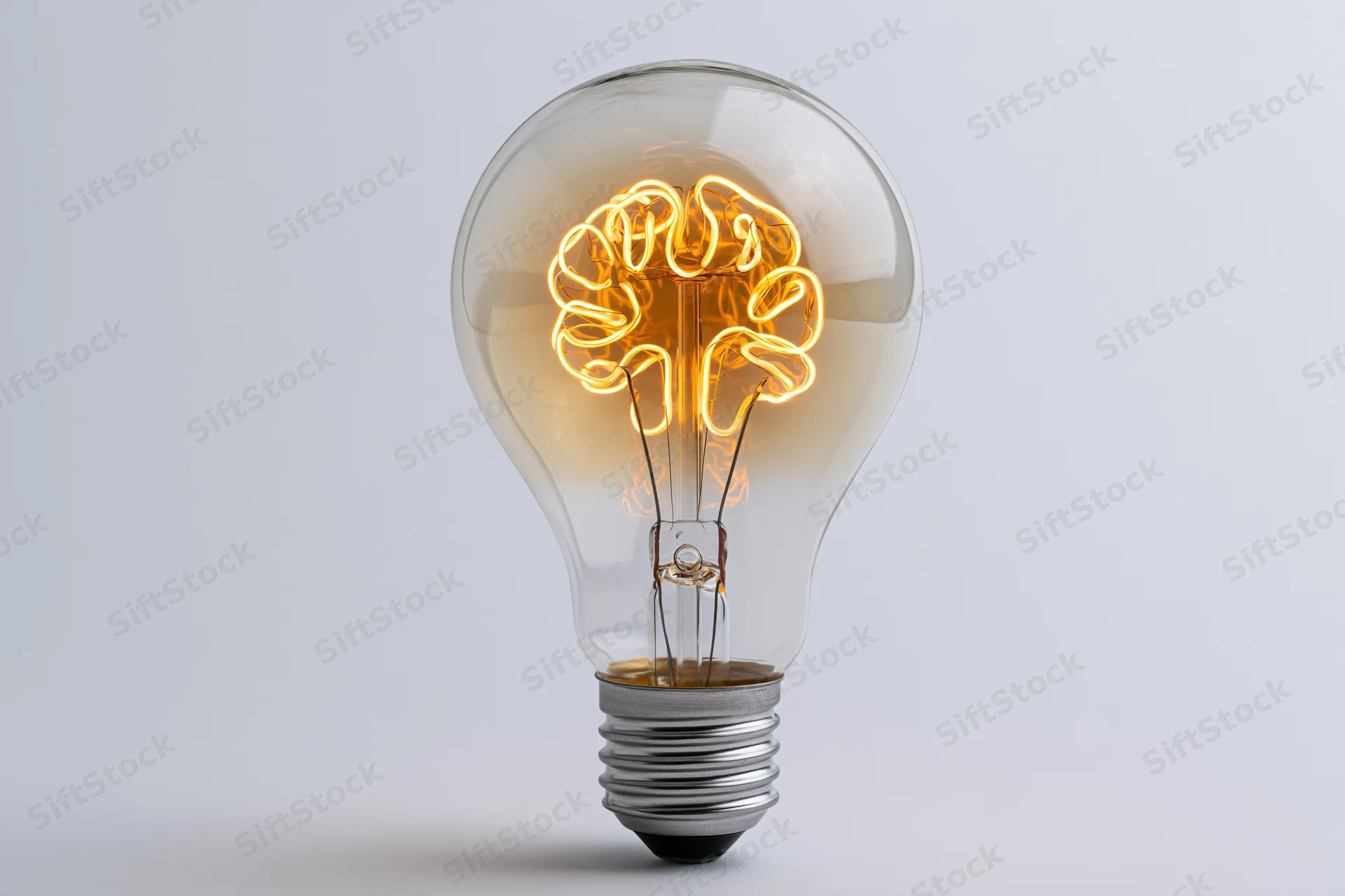 Lightbulb with brain-shaped filament glowing against white background