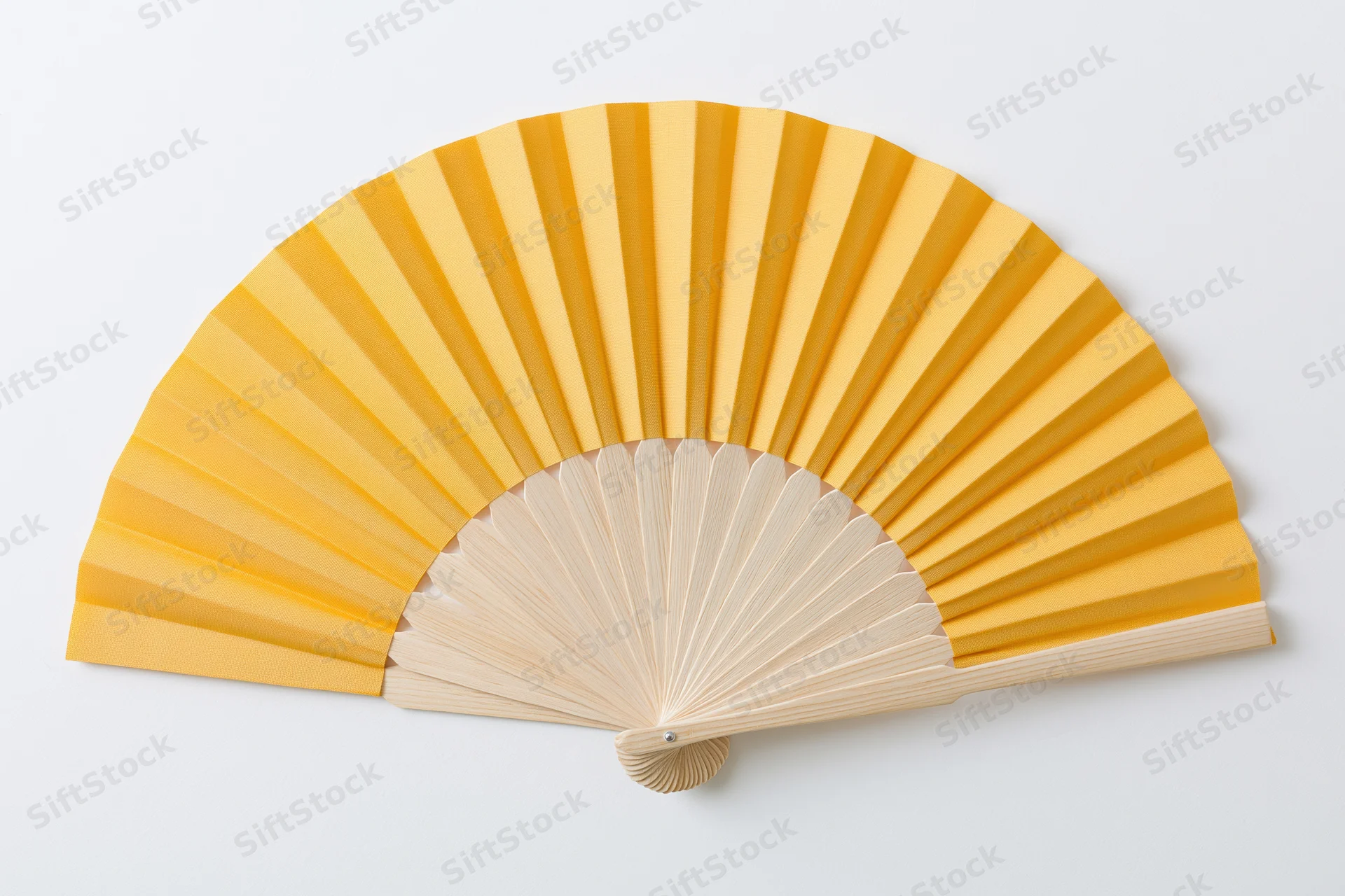 Fully opened yellow folding hand fan with wooden ribs on white background