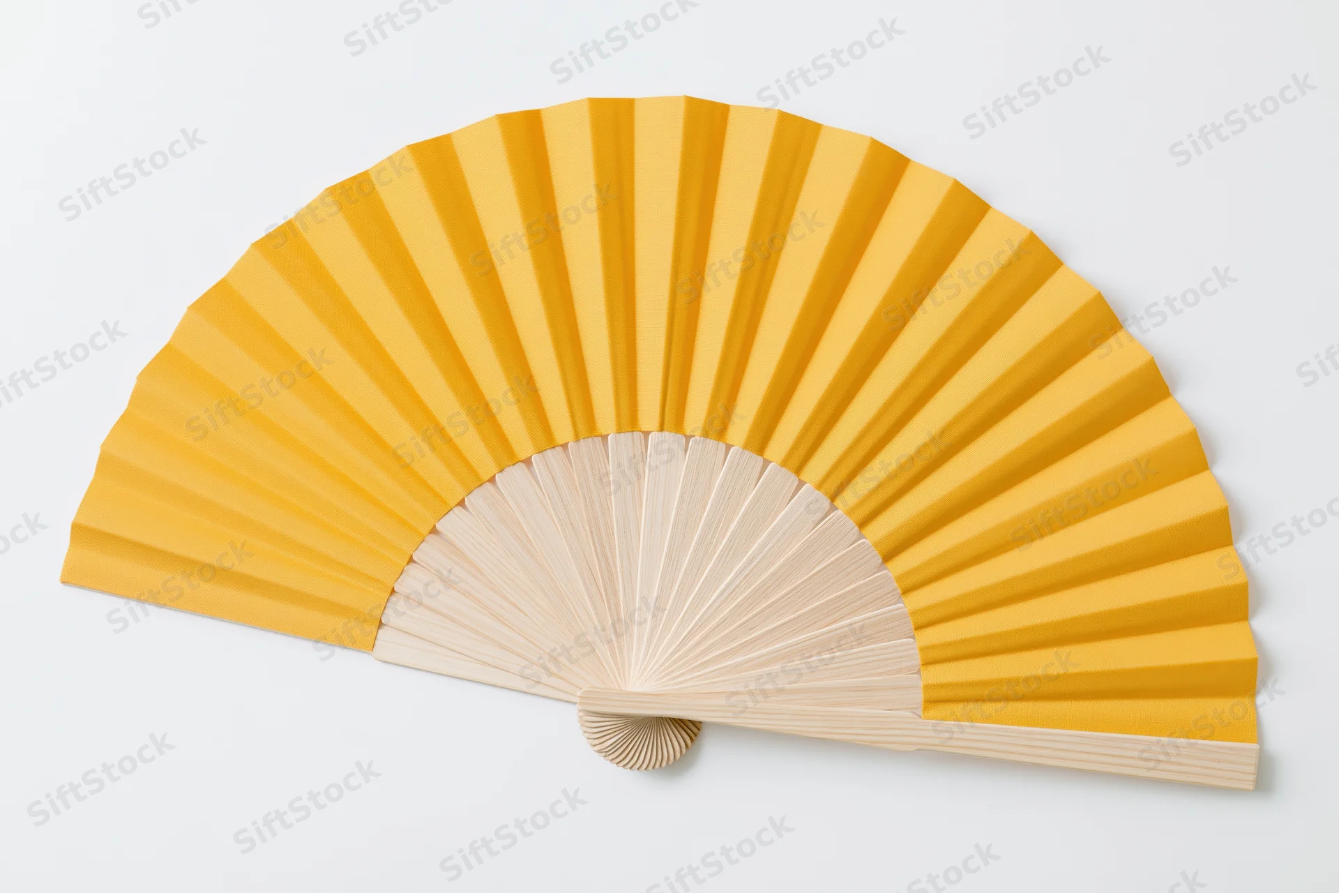 Fully opened traditional folding hand fan with plain yellow paper and wooden ribs on white background