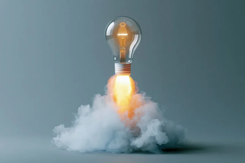 Lightbulb launching upward like a rocket with smoke and flame against a gray background