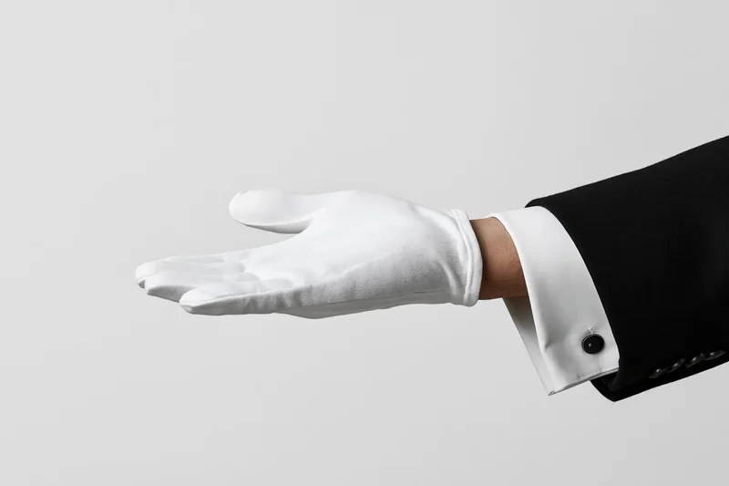 Man's gloved hand extended palm-up in an offering gesture