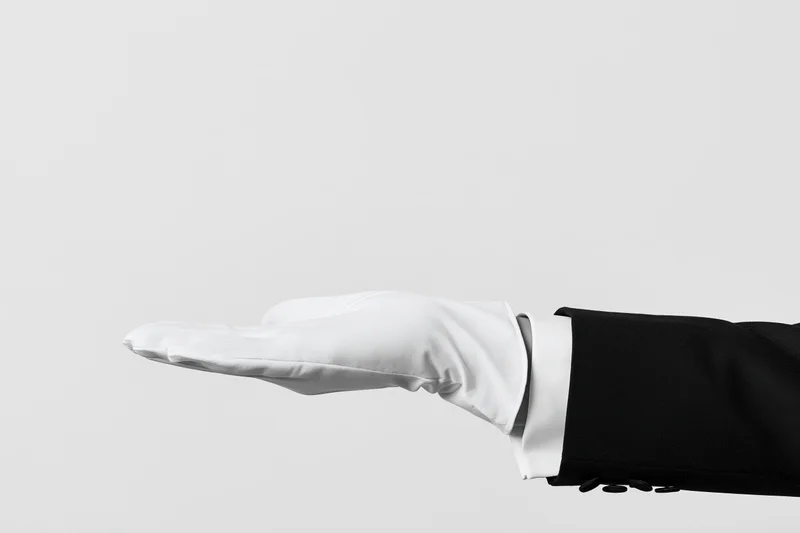Gloved hand extended palm-up in offering gesture against plain background
