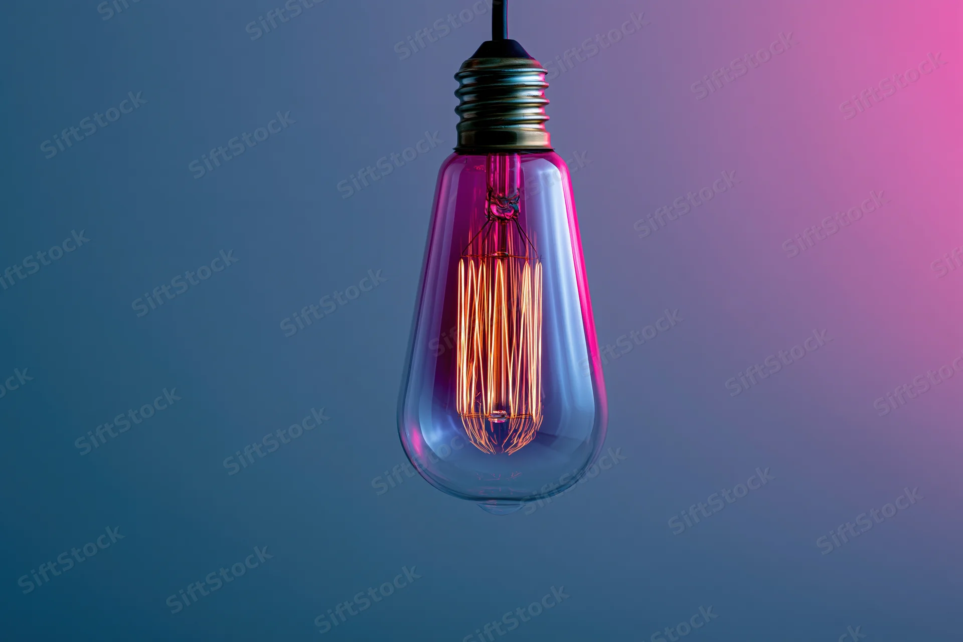 Glowing edison filament lightbulb hanging against a blue to pink gradient background