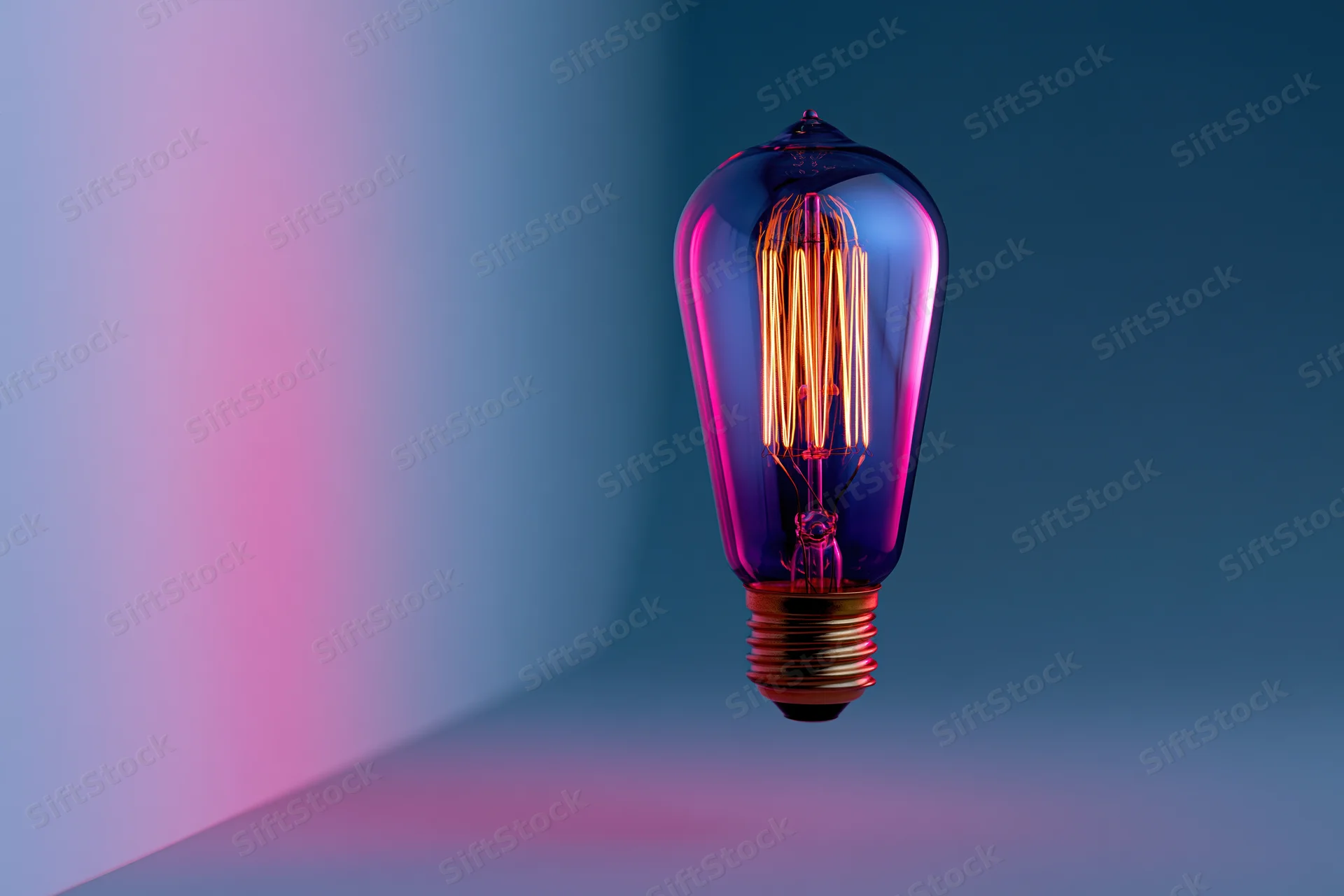 Glowing edison filament lightbulb floating in a gradient purple and blue studio space