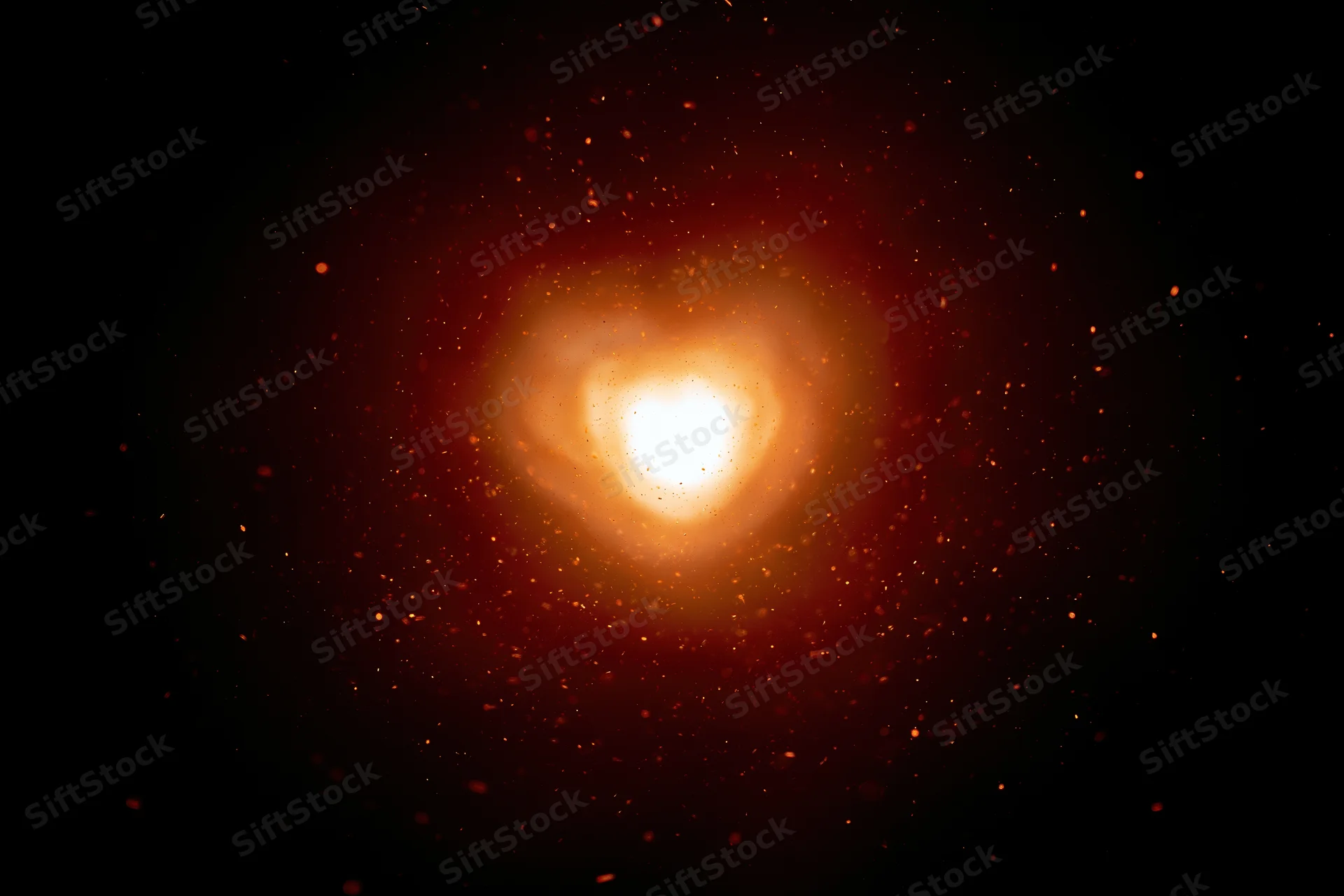 Glowing heart-shaped light centered in dark space with scattered particles