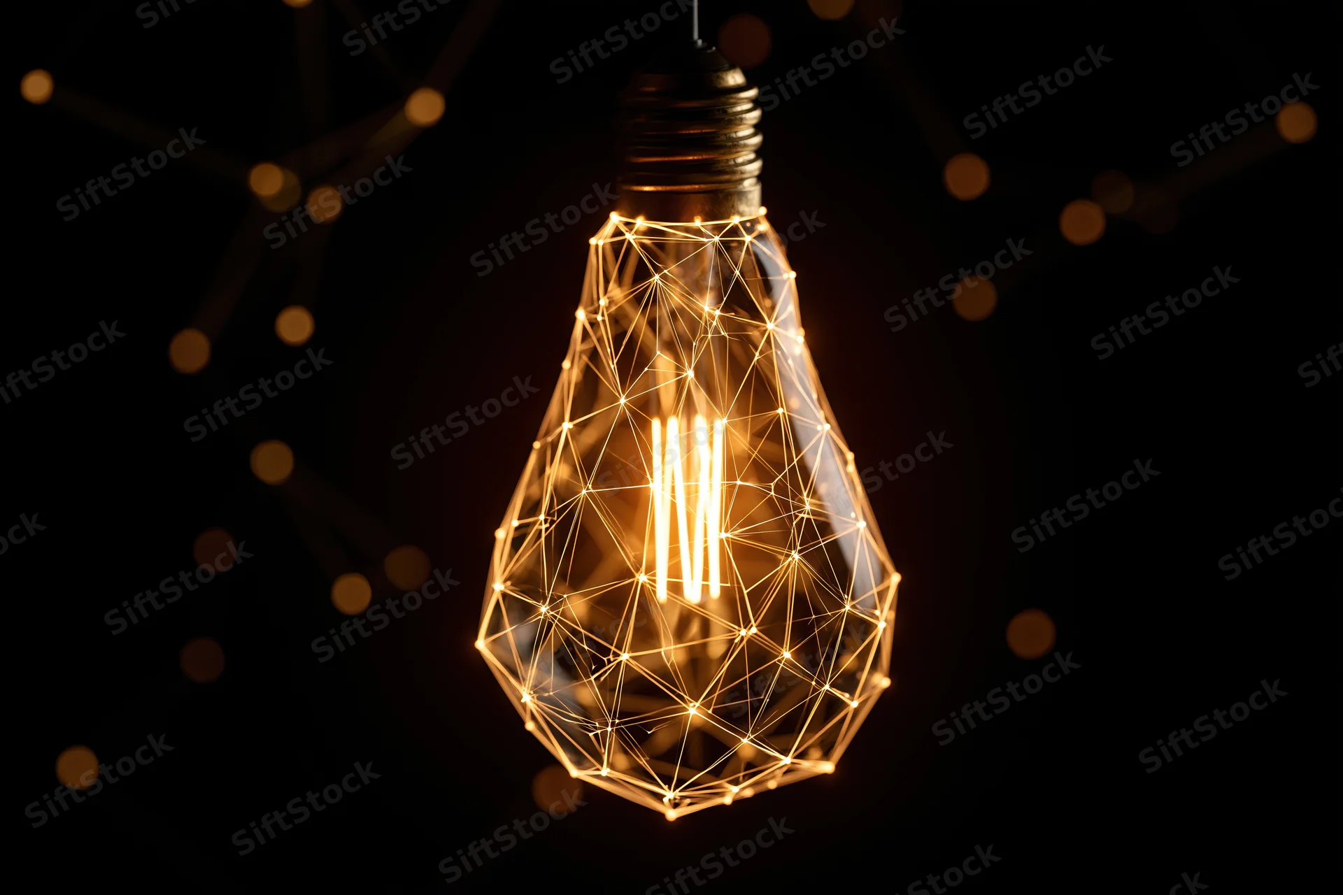 Glowing incandescent light bulb with geometric wireframe design against dark background