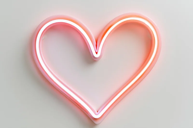 Glowing neon heart outline on a plain wall