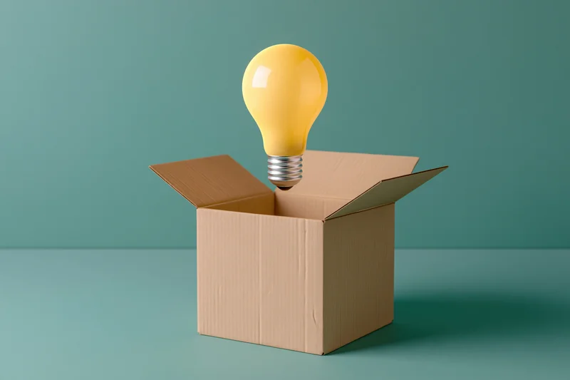 Yellow lightbulb floating above open cardboard box on teal surface