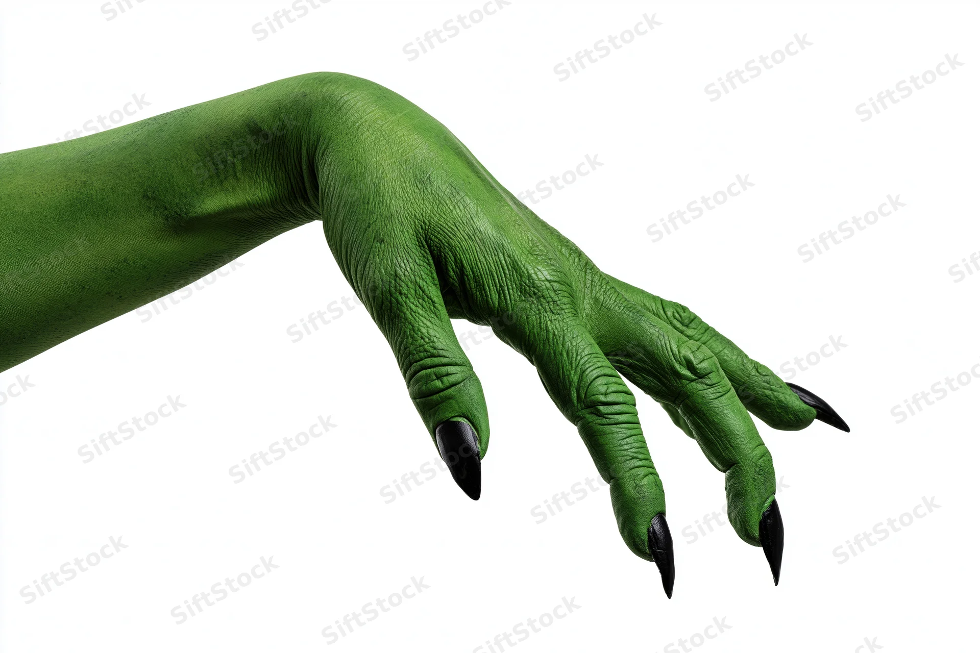 Green-painted hand with black claws reaching out against white background
