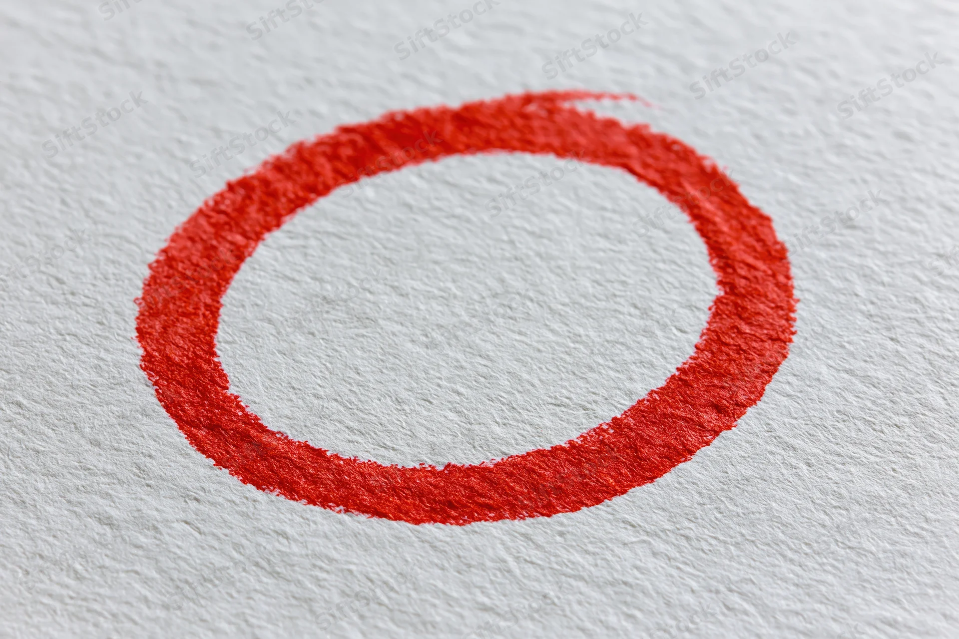Hand-drawn red marker circle on textured white paper