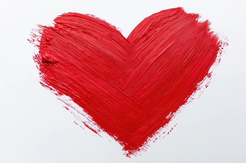 Hand-painted red heart with visible brushstrokes on a plain white background